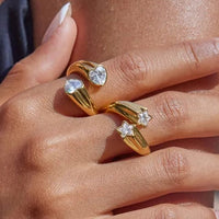 Gold crystal bypass ring model shot close up on fingers