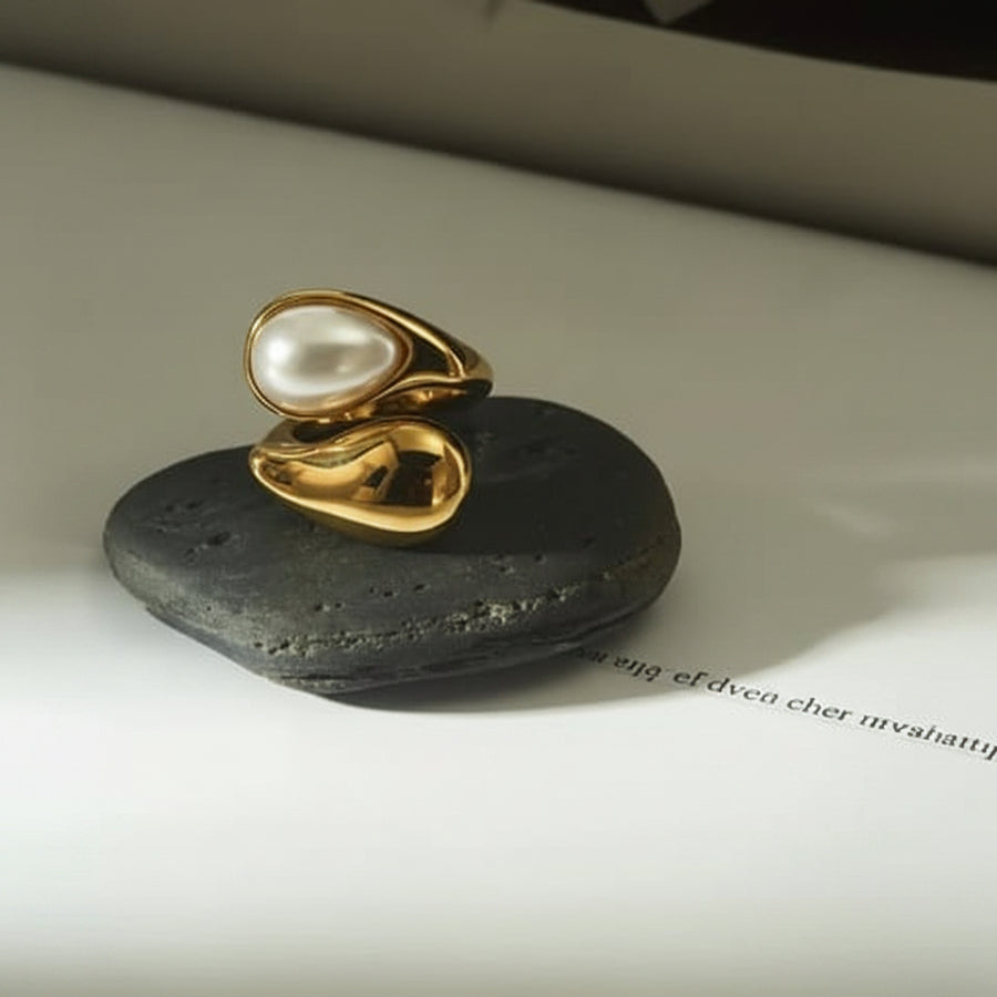 Gold teardrop open ring both variants pearl and tiger eye on rocks
